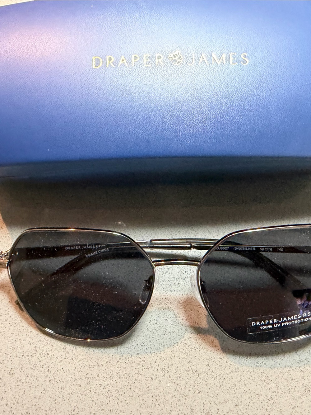 Draper James Silver-Tone Sunglass Arm with Navy Background